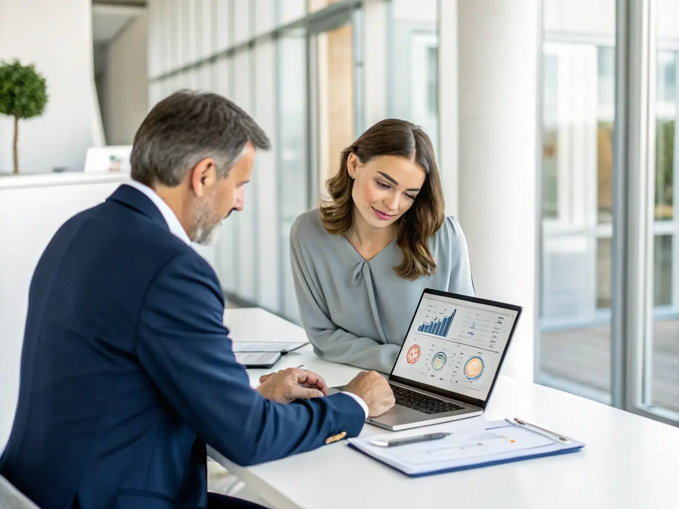 An image showing a consultant working with a client to analyze operational workflows, illustrating OrionLink's focus on operational efficiency.